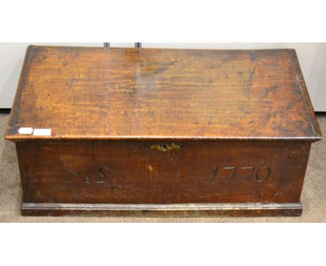 An 18th century oak chest of small proportions, with hinged lid above a front panel carved 'MS' and dated 1770, 72cm wide  
