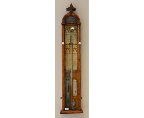 An oak Admiral Fitzroy barometer, circa 1890, exposed mercury tube with a double vernier scale, thermometer tube, atmosphere 