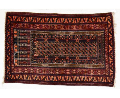 A Balouch prayer rug, West Afghanistan, the narrow indigo field beneath multiple Mihrabs enclosed by leaf and calyx borders, 