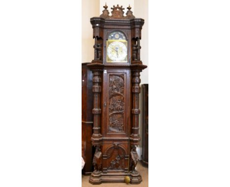 An impressive oak chiming longcase clock, circa 1890, hood with carved bear columns, carved trunk door with figures on horseb