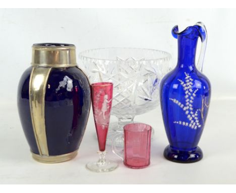 A cut glass punch bowl, enamel decorated blue glass ewer, two cranberry tinted enamel decorated pieces of glass, and an ovoid