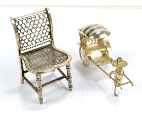 A late 19th/early 20th century Chinese Export silver miniature chair with mesh seat and ring turned stretchered legs, with ch