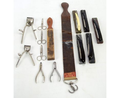 A small collection of vintage straight razors complete with wooden and leather strops, nail clippers, and further gentleman's