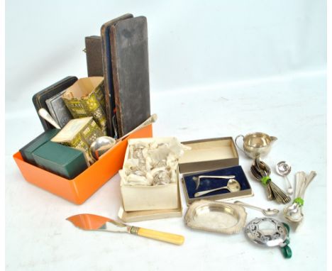 A quantity of silver plated items including three enamel glass holders, tea knives, a set of six napkin rings, servers, etc.