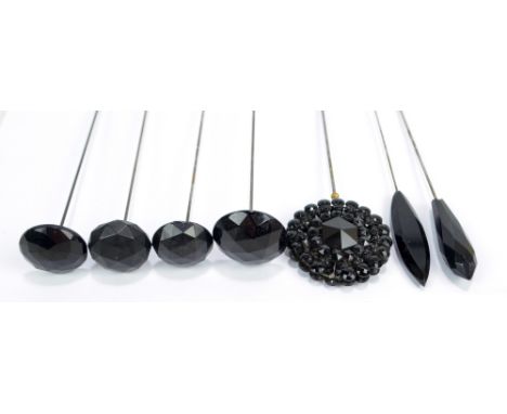 Seven various faceted jade hat pins including a squat globular example and a circular bead decorated example (7).