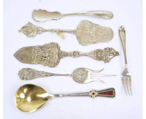 An Italian silver gilt and enamel decorated spoon, a German slice with embossed blade, a further similar example, two forks a