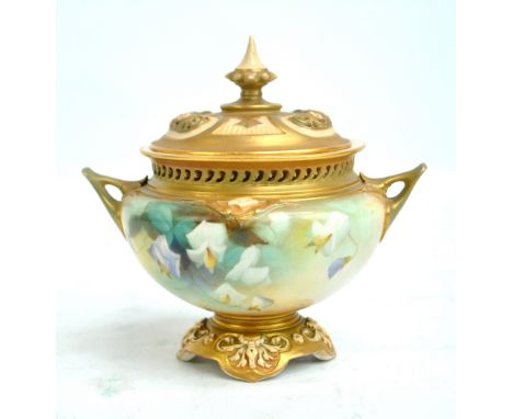 A Royal Worcester hand painted gilt heightened twin handled potpourri bowl and cover, decorated with floral motifs, raised on