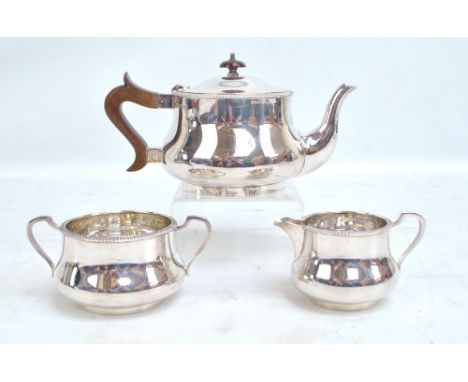 LEE & WIGFULL; a George VI hallmarked silver three piece tea set of squat baluster form comprising a teapot, length 23cm, a t