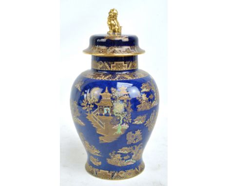 A Carlton Ware 'Kang Hsi' pattern decorated baluster vase and cover with gilt Dog of Fo finial on powder blue ground, marked 