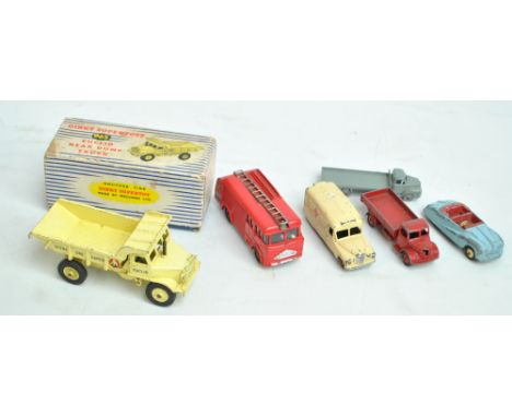 A small group of Dinky diecast model vehicles comprising boxed 965 'Euclid Rear Dump Truck', 'Fire Engine', 'Daimler Ambulanc