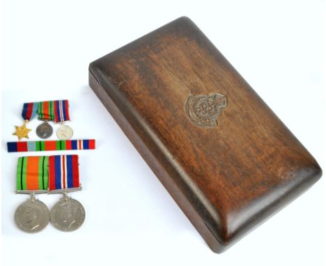 Two WWII medals, unascribed, a miniature trio and a matching ribbon bar, contained in a wooden box with Royal Army Medical Co