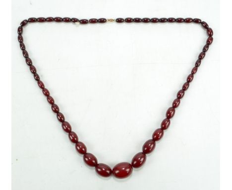 A vintage cherry amber graduated bead necklace, overall length 78cm, largest bead is 2.5 x 2cm, approx 65g.
