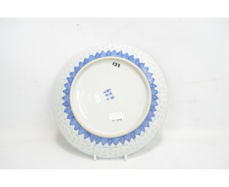 A 19th century Chinese porcelain circular shallow bowl painted in underglaze blue with blossoming chrysanthemum within border