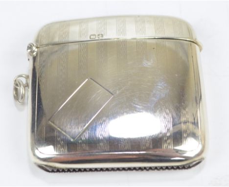 E J TREVITT & SONS; a George V hallmarked silver rounded vesta case with engine turned decoration and vacant rectangular cart