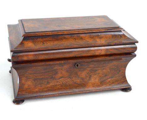 An early Victorian rosewood sarcophagus tea caddy with hinged lid (now lacking interior), raised on bun feet, width 36cm. CON