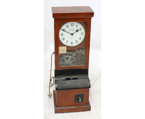 NATIONAL TIME RECORDER CO LTD; an oak cased clocking in clock, the dial set with Arabic numerals, with cast iron slip apertur