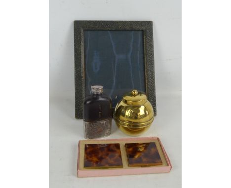 A hip flask with glass body and stitched leather upper section, a photograph frame, a boxed compact and case and a 1924 Wembl