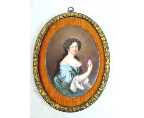 A 19th century Continental oil on porcelain half-length portrait depicting a lady holding a cameo, signed indistinctly lower 