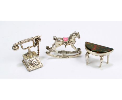 SJ ROSE & SON; an Elizabeth II hallmarked silver dolls house miniature demi-lune table with inset agate to top, London 1977, 