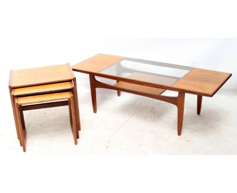 A G-Plan teak and glass coffee table with magazine shelf, height 42.5cm, length 137cm, width 51cm, together with a nest of th