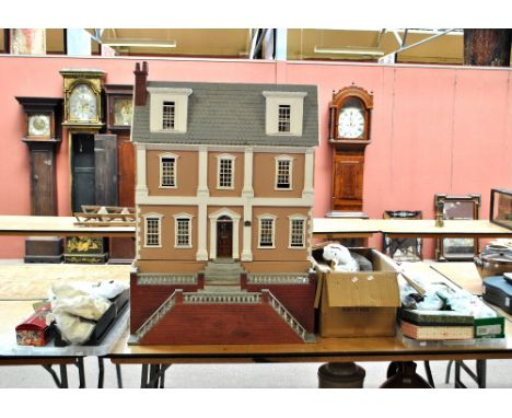 A large Victorian style doll's house with hinged front and one side of the roof with sash windows, enclosing nine rooms and c