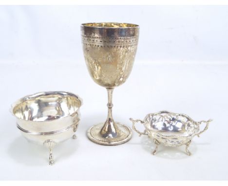 Three variously hallmarked silver items comprising a Victorian trophy goblet engraved with garlands and inscribed 'HH 1913', 