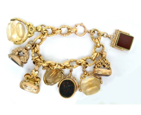 An 18ct yellow gold belcher link bracelet (Italian marked), with three 9ct gold mounted seals and five further unmarked seals