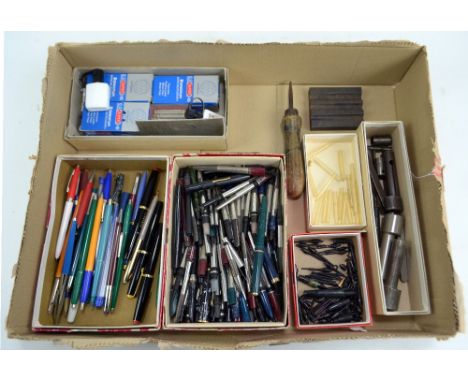 A group of pen repair tools and spare parts including a large quantity of fountain pen reservoirs, small plastic bladders, ni