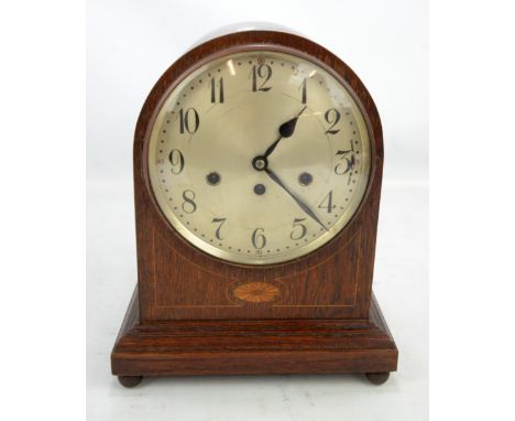 An Edwardian oak and inlaid eight day bracket clock, the silvered dial set with Arabic numerals, with Junghans movement and c