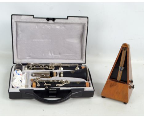 A modern cased Buffet clarinet, and a Maelzel metronome (2). CONDITION REPORT: Model B12