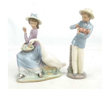 A Lladro figure of seated girl and goose eating grapes, and a Nao figure of a boy with a puppy (2).