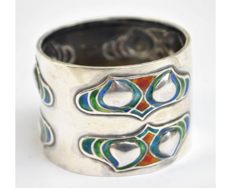 LIBERTY & CO; Cymric, an Edwardian Arts and Crafts hallmarked silver and enamel decorated napkin ring, Birmingham 1904, diame