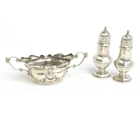 WILLIAM HUTTON & SONS LTD; a pair of George V hallmarked silver peppers of octagonal baluster form, height 9cm, Birmingham 19