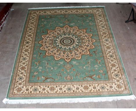 A green ground Keshan carpet, 280 x 200cm.