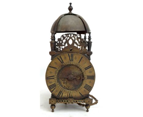 An 18th century brass lantern clock, the chapter ring set with Roman numerals, the floral decorated dial inscribed 'Robert As