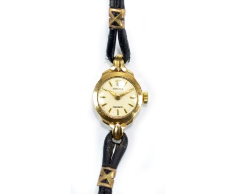 ROLEX; a lady's vintage 9ct yellow gold cased wristwatch with circular dial set with gold batons and with 17 rubis movement, 