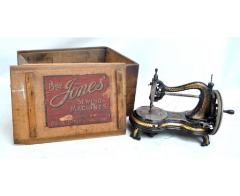 A vintage Jones gilt heightened sewing machine in original box, with trade label to the sliding lid.