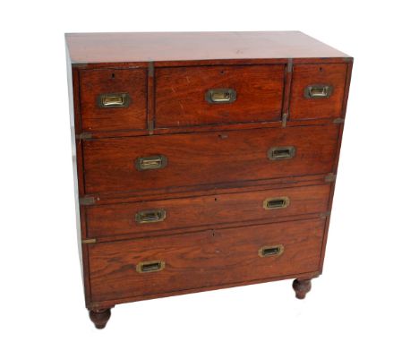 An Army & Navy CSL teak and brass bound campaign chest with secrétaire and short drawers above three long drawers to bun feet