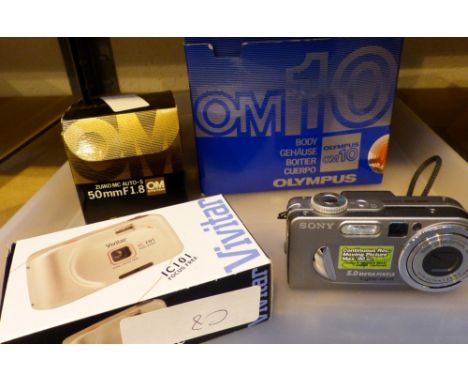 Olympus OM 10 Ser.1821134. camera, 50mm lens, and other camera equipment.