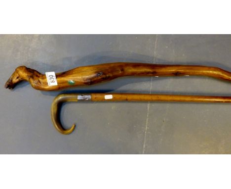 Unusual heavy hand carved walking stick and a horn handled.
