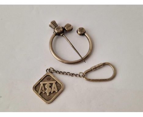 A silver kilt pin and silver key ring