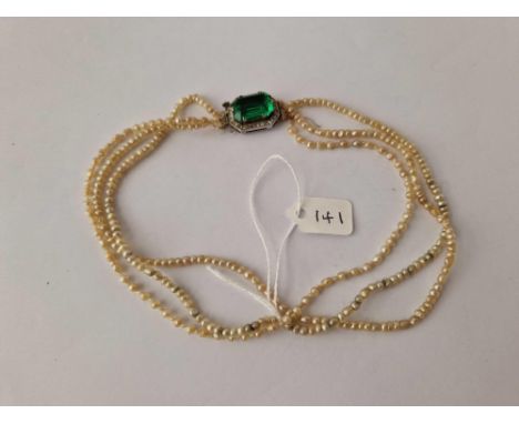 Antique 3 row natural pearl necklace mounted on a green &amp; white paste clasp.