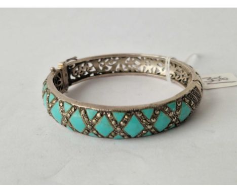 A fancy silver marcasite and turquoise bangle
