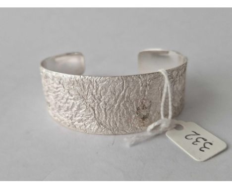 A silver bark effect torque bangle by MB