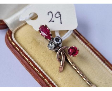 A boxed gold rose diamond and garnet stick pin 3.1 gms