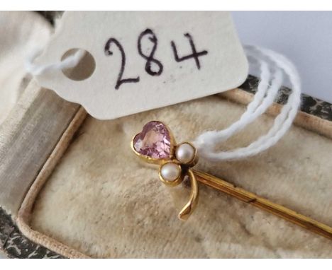 A boxed gold stick pin with pearl and pink stone