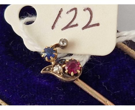 A boxed gold ruby diamond and sapphire stick pin