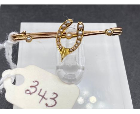 A antique wishbone shaped pearl brooch set in high carat gold  