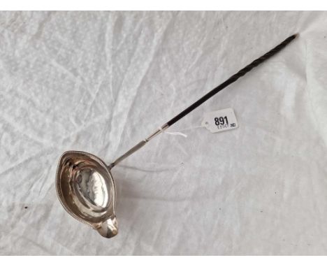 A Georgian toddy ladle with whale bone handle, London 1787