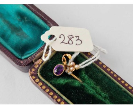 A boxed gold stick pin with pearl and amethyst